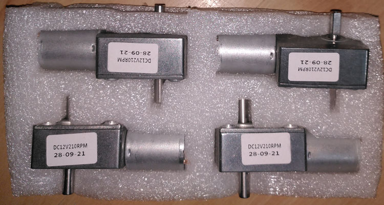 Four metal housed worm-drive gear motors.