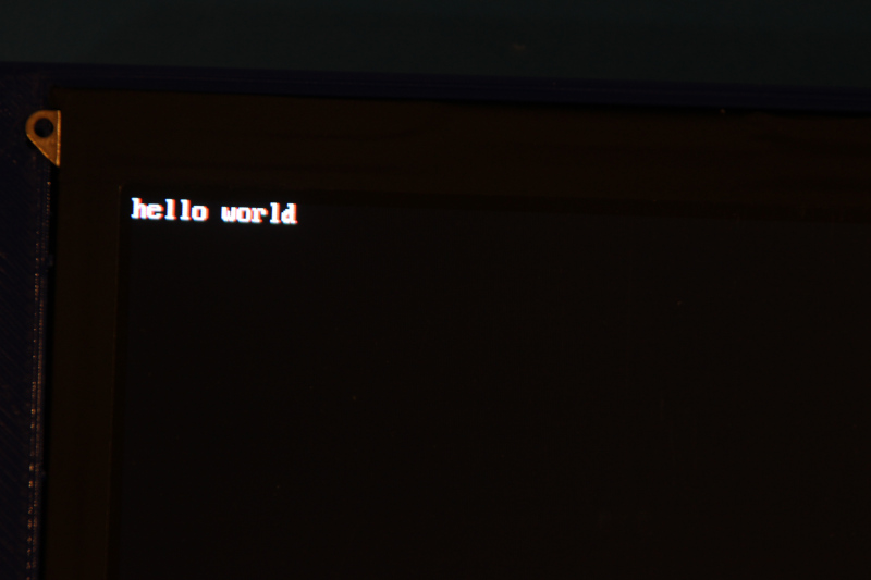 The words 'hello world' in a basic console font in the corner of a black screen.